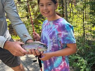 photo of student in summer program holding a fish