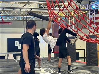 photo of student in summer program completing the ninja course