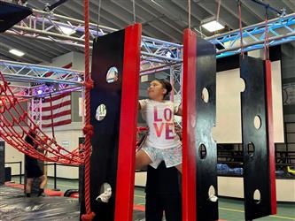 photo of student in summer program doing ninja gym