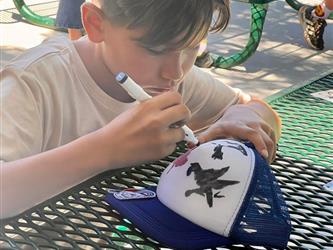 photo of student in summer program designing a trucker hat
