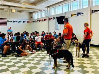 photo of search and rescue representatives and their dogs at summer program presentation