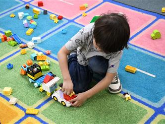 TK student playing with trucks
