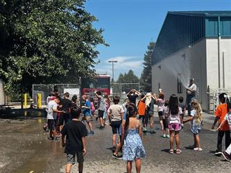 Photo of local fire department visit and helping with water day