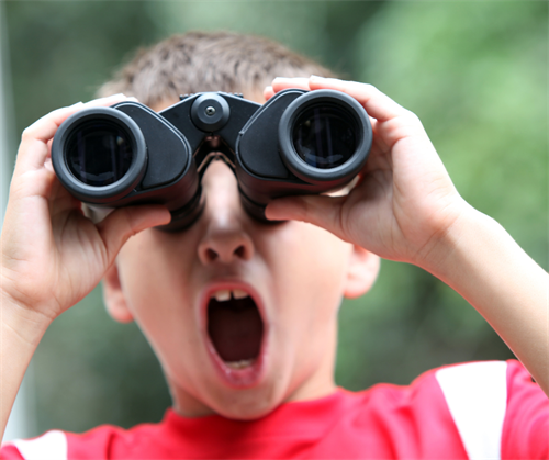 child looking through Binoculars